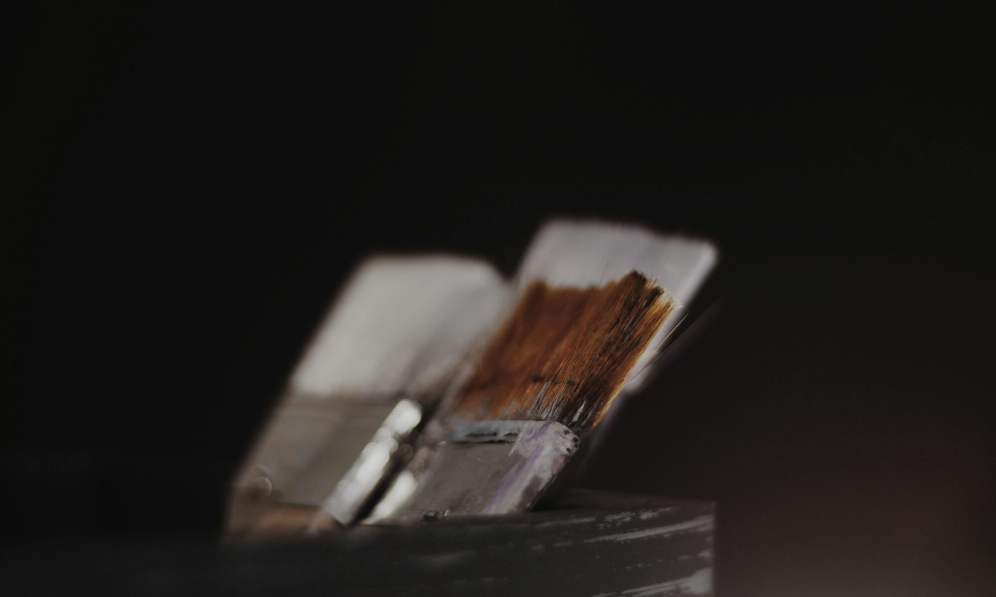 Artistic close-up of paint brushes highlighting texture and depth.